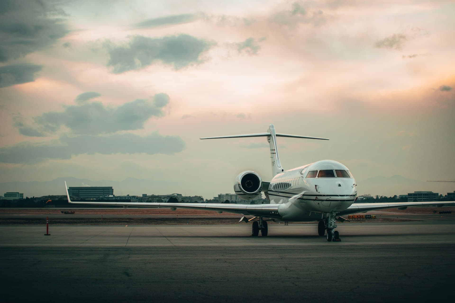 Private jet on the tarmac at sunset